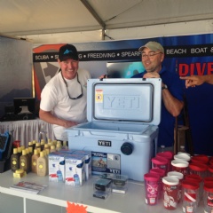 Divers Direct staff member, Tim, showing an excited customer our new line of Yeti Coolers at the Fort Lauderdale International Boat Show.