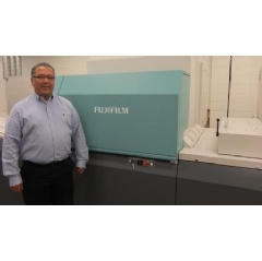 Jeff Hernandez, VP, Classic, proudly stands next to Fujifilms J Press 720S at their Broadview, Illinois production facility.