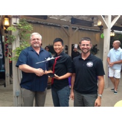Doug Shaffer presents members of the team from San Diego State University with a Triton model they won in a raffle.