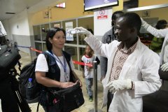 A WHO staff gets her body temperature checked at Lugin Airport, Freetown, Sierra Leone. Photo: WHO Sierra Leone