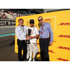 Ken Allen, CEO, DHL Express (left) and Arjan Sissing, SVP, Corporate Brand Marketing, Deutsche Post DHL (right) hand the trophy to Lewis Hamilton before the 2014 FORMULA 1 ETIHAD AIRWAYS ABU DHABI GRAND PRIX.