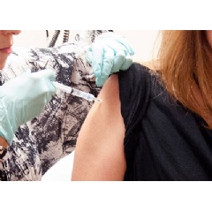 A 39-year-old woman, the first participant enrolled in VRC 207, receives a dose of the investigational NIAID/GSK Ebola vaccine at the NIH Clinical Center in Bethesda, Maryland. on Sept. 2, 2014.