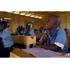 Students inside a newly built classroom at a camp for internally displaced persons in Port-au-Prince, Haiti. UN Photo/Logan Abassi