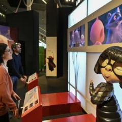 Visitors play with the The Incredibles module. 