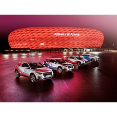 Four Audi Q2 cars sporting the colors of the clubs advertise the Audi Cup