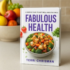 Hardcover copy of Fabulous Health: A Simple Plan To Get Well And Stay Well on a table in front of a bowl of fruit.