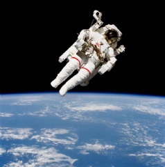 Astronaut Bruce McCandless II, STS 41-B mission specialist, participates in the first use of a nitrogen-propelled, hand-controlled device called the Manned Maneuvering Unit (MMU). (Credits: NASA)
