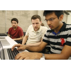 Shiva Gopalan, a computer engineering masters student at Texas A&M University(far right), confers with IBM developers Henrique Copelli Zambon (center) and Luiz Aoqui, during an IBM hosted Spark Hackathon at Galvanize. (Credit:George Nikitin)