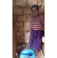 This adaptation of the original SaTo sanitary toilet pan now includes a wider flange. This feature facilitates installations into mud or wood floors, as pictured here in a bathroom in Rwanda.