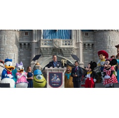 Walt Disney World President George A. Kalogridis, surrounded by a flurry of beloved Disney characters, addresses Magic Kingdom Park guests during the 45th anniversary of Walt Disney World, Saturday, Oct. 1, 2016.