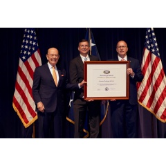James K. Hawley, Director of International Business Development (right), and Philip Lesniak, Import/Export Manager (center), of Automated Packaging Systems, receive the Presidents E Award for Exports from Wilbur Ross, Secretary of Commerce (left).