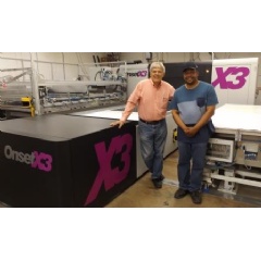 Mark Turk, left, president and CEO, and Alvin Page, inkjet press operator, alongside the Inca OnsetX3 with three-quarter automation at International Label, Elk Grove Village, Illinois.