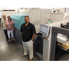Dino and Fernanda Pereira, with son Shawn, alongside the J Press 720S at the Spectrum Lithograph facility in Fremont, California.