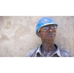 Ylerne Divert, is a construction worker in the Sapotille neighborhood of Carrefour, Haiti. CARE is paving steps and walkways as part of the Neighborhood Improvement Project