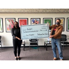 Karma Sauce founder Gene Olczak presenting the $5,500 donation.