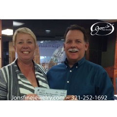 Cocoa, Fla. – Buffy McKinney, regional director the American Heart Association, receives a $450 donation from Jon Miller of Jon’s Fine Jewelry as part of its Diamonds for Hearts campaign during February.