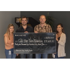 Josh Hendren, General Manager for War Commander: Rogue Assault (third from the left), and members of the KIXEYE marketing team presenting the check.