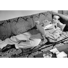Cole Porter composing as he reclines on a couch in the Ritz Hotel during out-of-town tryouts for DuBarry Was a Lady (1939). Porter insisted on luxurious accommodations stocked with his favourite foods and medicines (see complete caption below)