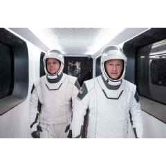 NASA astronauts Bob Behnken, left, & Doug Hurley, wearing SpaceX spacesuits, walk through the Crew Access Arm connecting the launch tower to the SpaceX Crew Dragon spacecraft during a dress rehearsal at NASA... Credits: SpaceX (Complete caption below