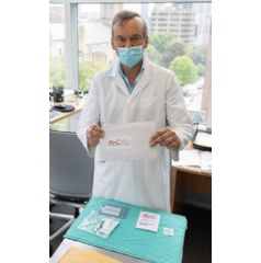 Dr. Prabhat Jha holds a return envelope for the Ab-C study.
