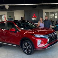 Dan Arrotta poses with his wife in the showroom of the all-new Arrottas Mitsubishi.