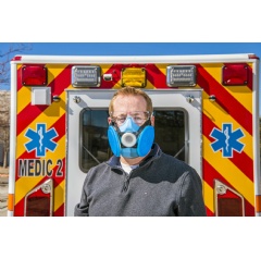 Sandia National Laboratories engineer Todd Barrick models a prototype of the comfortable, sterilizable, all-day respirator he and 16 colleagues developed to complement disposable N95 masks. (Photo by Randy Montoya)