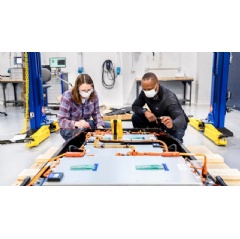 Dane Hardware, Ford Motor Co. design and release engineer, and Mary Fredrick, Ford Motor Co. battery validation engineer, measure the voltage of a battery using a digital multi-meter at Ford’s Battery Benchmarking and... (see complete caption below)
