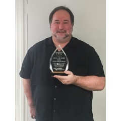 Jackie Van Horne holding the 2015 Maryland HACC Award