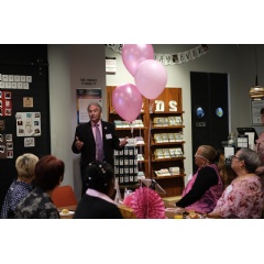 Pink Table Brunch attendees listening to remarks by Joseph J. Cappello, co-founder of Are You Dense, Inc, and Are You Dense Advocacy, Inc.at the FUJIFILM Wonder Photo Shop in New York.