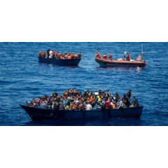 Wooden boats filled with people are rescued by MSF Vos Prudence in the sea off the coast of Libya, on June 9, 2017.