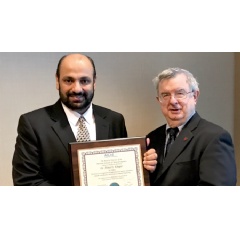 Ahmed S. Khogeer is presented with a Fellowship Award by David Eckhardt, vice chairman of the American Institute of Chemical Engineers Fellows Council.