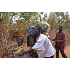 An internally displaced Congolese family carry their belongings as they trek in search of safety in Ituri province, February 2018. © UNHCR/Anita Cadonau