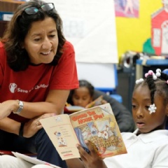Janti Soeripto, president and chief operating officer of Save the Children U.S., reads with second grader Kaliya at one of Save the Childrens literacy programs in Tennessee.
Photo by Shawn Millsaps for Save the Children.