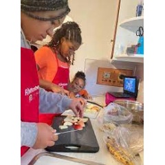 Flint Families Cook, co-facilitated by a chef and dietitian, encourages families to cook healthy meals together at home. (See complete caption below)