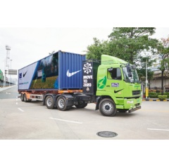 Electric heavy-duty prime mover transporting goods as part of Nikes sustainable first-mile transportation initiative in Southern China.