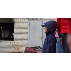A boy looks at his home that was destroyed by a drone attack in Kyiv, Ukraine. Photographed May 5, 2025. Credit: Anastasiia Olinska / Save the Children.
