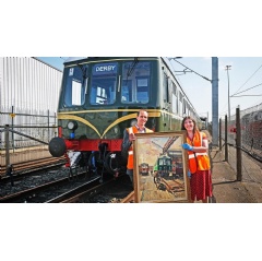 Andy Butters, MD, Derby Litchurch Lane Works, Alstom; Eilish Clohessy-Dennis, Curator of Making, Derby Museums, Terence Cuneos DMU at Derby Carriage and Wagon Works in front of Derby-built Class 108 (Credit  Ian Castledine)