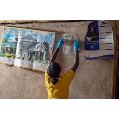 David Amollo/Unitaid
A community health worker installs a spatial repellent in a home in Kenya.