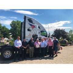 The Colorado Department of Labor presented Navajo with their certificate of approval in front of a Navajo Express military wrapped truck.