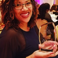 Co-author Dr. Eurydice Stanley proudly displays The Worst First Day’s 2019 Indie Author Legacy Award.