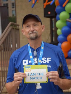 BASF employee, Kelly Brooks, proudly holds his I am a Match sign at the awards ceremony for the Be The Match Walk +Run.