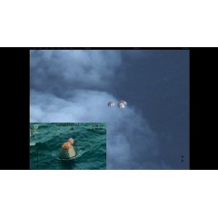 Following a perfect launch and more than 4 hours in Earth’s orbit, NASA’s Orion spacecraft is seen from an unpiloted aircraft descending under 3 massive red and white main parachutes... Image Credit: NASA