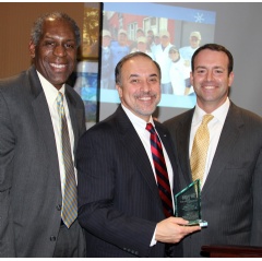 Carlton Daniels, chair of the board of directors of Habitat for Humanity Newark (left), and Jeffrey Farrell, executive director of the organization (at right), Sam Delgado, vice president of external affairs for Verizon New Jersey.