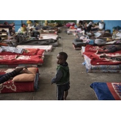 © UNICEF/UN077995/Romenzi
A child walks past mattresses laid on the floor in the women’s section of the Al-Nasr detention centre in Zawiya, Libya, Sunday 20 August 2017.