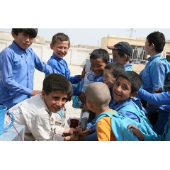 © UNICEF/UNI111396/Froutan
Boys crowd around a hand pump for a drink of water in a school in the city of Mazar, north Afghanistan. 2011