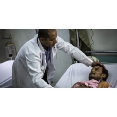 Dr Ahmed al Jouneid, head of the emergency department, tends to a patient at the Al Koweit university hospital in Sana’a.