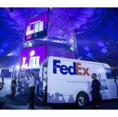 FedEx Express courier Edward Graham assists Super Bowl XLVII Champion and two-time All-Pro center Matt Birk with the delivery of the Vince Lombardi Trophy to the Super Bowl Experience Driven by Genesis in Minneapolis, Minn. Omar Vega/AP Images
