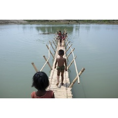© UNICEF/UN0203395/Sokol
Rohingya children from Myanmar play on a bamboo bridge crossing a shallow body of water at high tide in Shamlapur refugee camp, Cox’s Bazar District, Bangladesh.