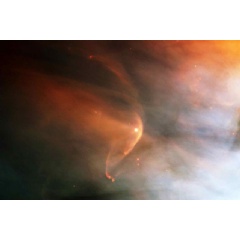 An example of an interstellar collisionless shock is seen in this photo of a bow shock in the Orion Nebula.
Image credit: NASA and the Hubble Heritage Team (STScI/AURA)
