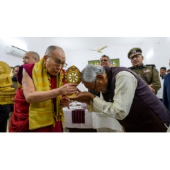 His Holiness the Dalai Lama offering Bihar Chief Minister Nitish Kumar a Dharma Wheel at the conclusion of their meeting at the Chief Minister’s residence in Patna, Bihar, India. Photo by Lobsang Tsering